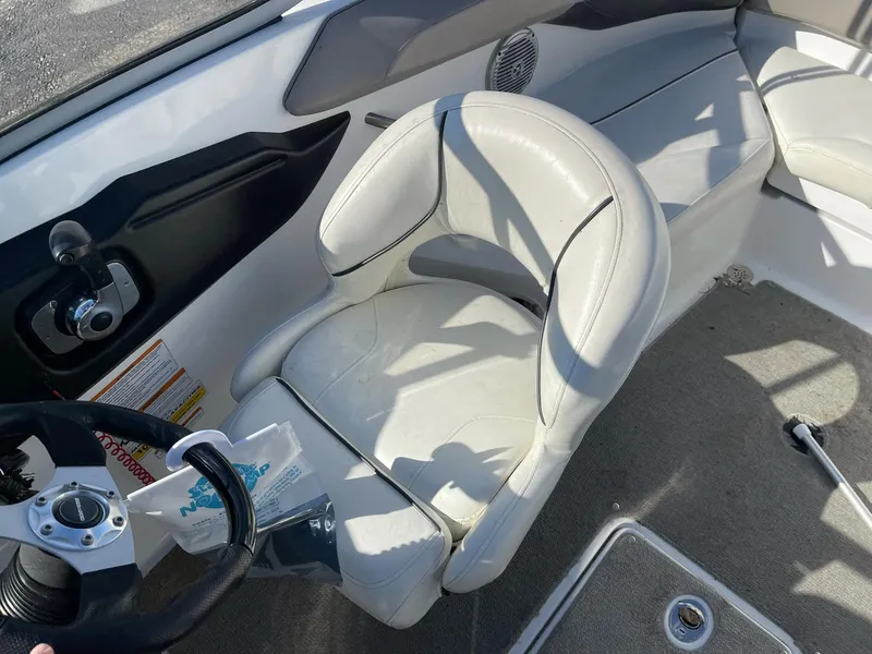 Slide: The Image of Interior of 2010 Sea-Doo 210 Challenger boat with white seating and steering wheel. - 8