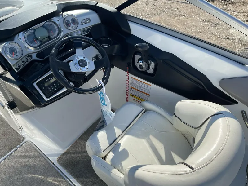 Slide: The Image of 2010 Sea-Doo 210 Challenger cockpit with steering wheel and dashboard controls. - 9