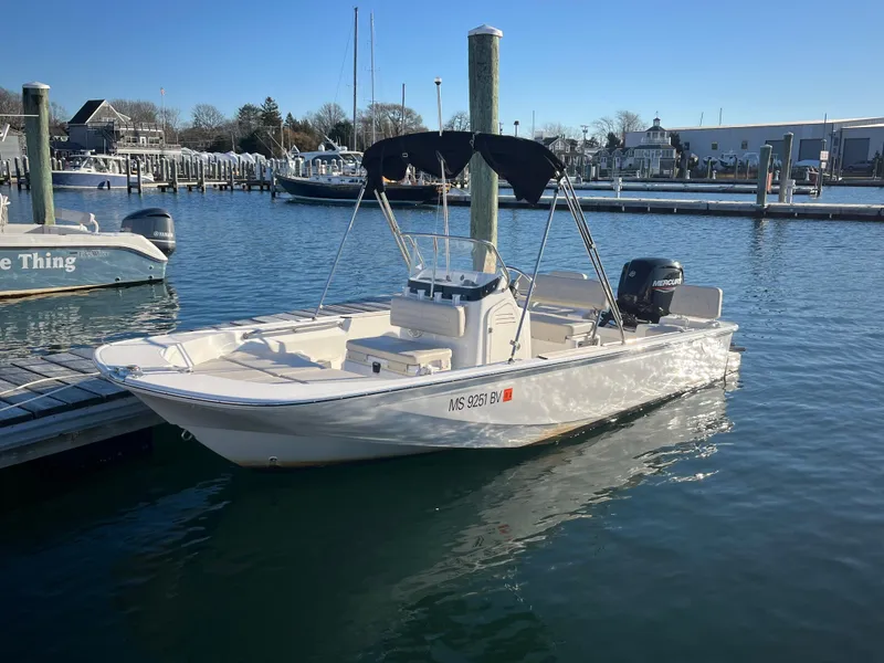 Slide: The Image of 2020 Boston Whaler 170 Montauk boat docked in marina under clear blue sky. - 0