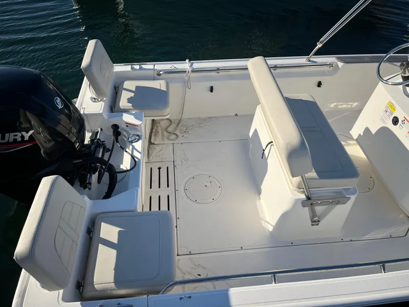 Slide: The Image of 2020 Boston Whaler 170 Montauk boat interior with seating and Mercury engine. - 13