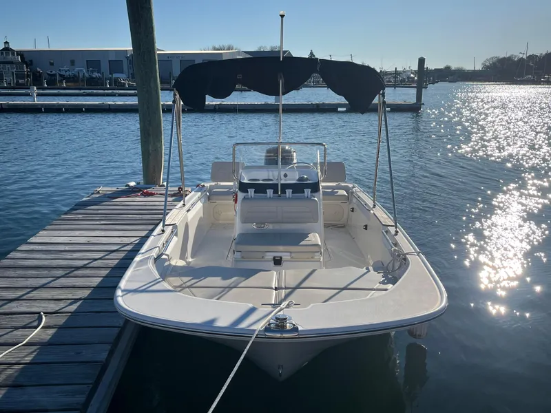 Slide: The Image of 2020 Boston Whaler 170 Montauk boat docked in sunny marina. - 2