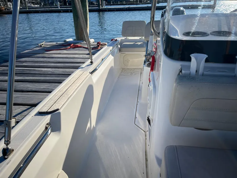 Slide: The Image of 2020 Boston Whaler 170 Montauk boat interior by dock, sunny day. - 9