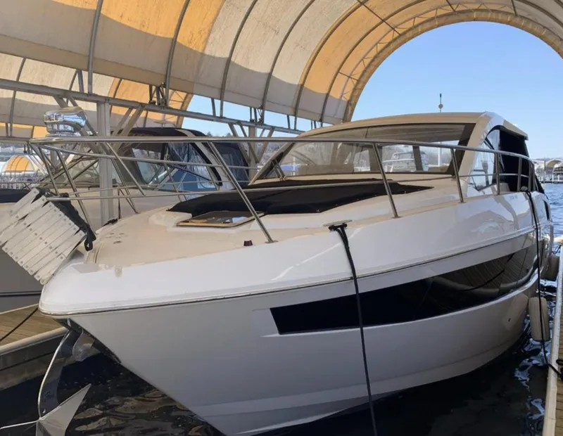Slide: The Image of 2018 Cruisers 390 Express Coupe docked under canopy. - 1