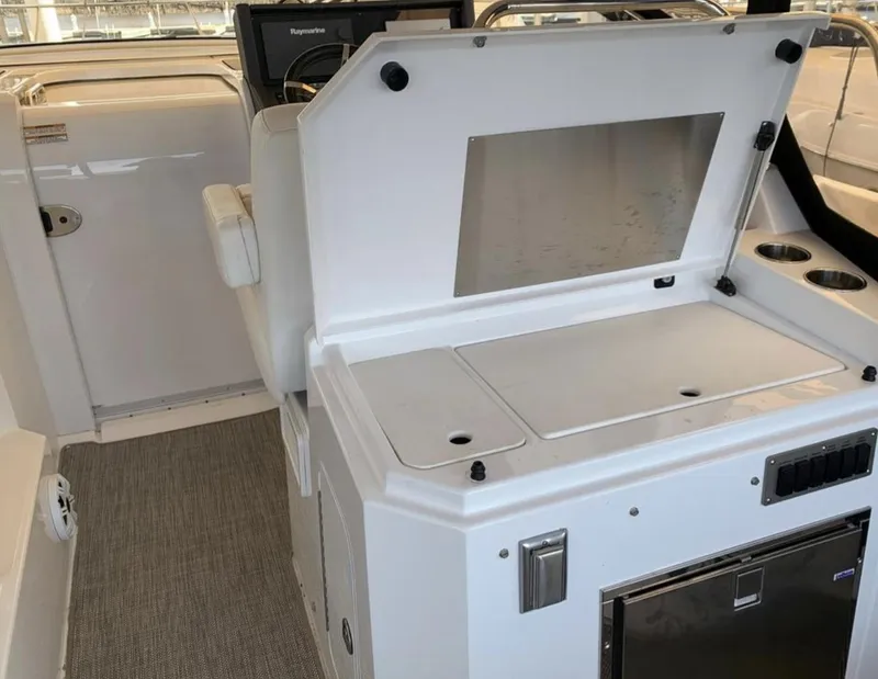 Slide: The Image of 2018 Cruisers 390 Express Coupe interior with kitchenette and seating area. - 11