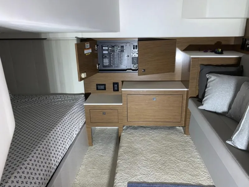 Slide: The Image of 2018 Cruisers 390 Express Coupe cabin interior with bed, seating, and control panel. - 15