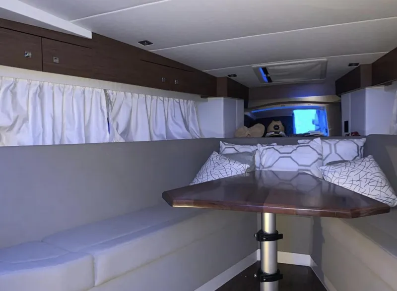 Slide: The Image of Interior of 2018 Cruisers 390 Express Coupe with cozy seating and modern design. - 17