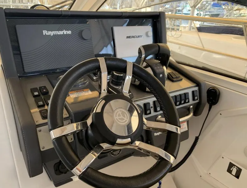 Slide: The Image of 2018 Cruisers 390 Express Coupe helm with Raymarine and Mercury controls. - 4