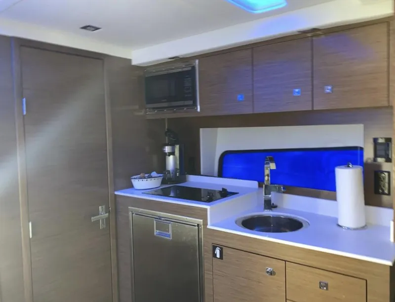 Slide: The Image of 2018 Cruisers 390 Express Coupe kitchen with modern appliances and sleek cabinetry. - 13