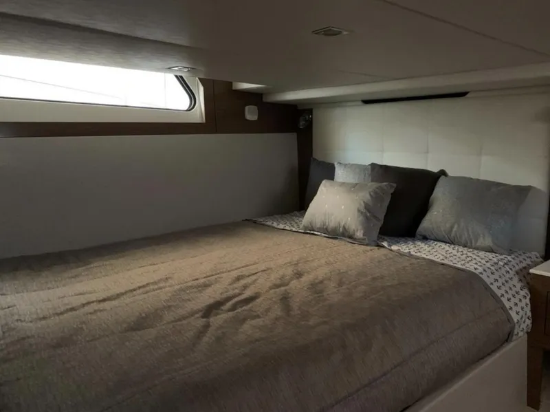 Slide: The Image of Luxurious cabin interior of 2018 Cruisers 390 Express Coupe with cozy bedding. - 14