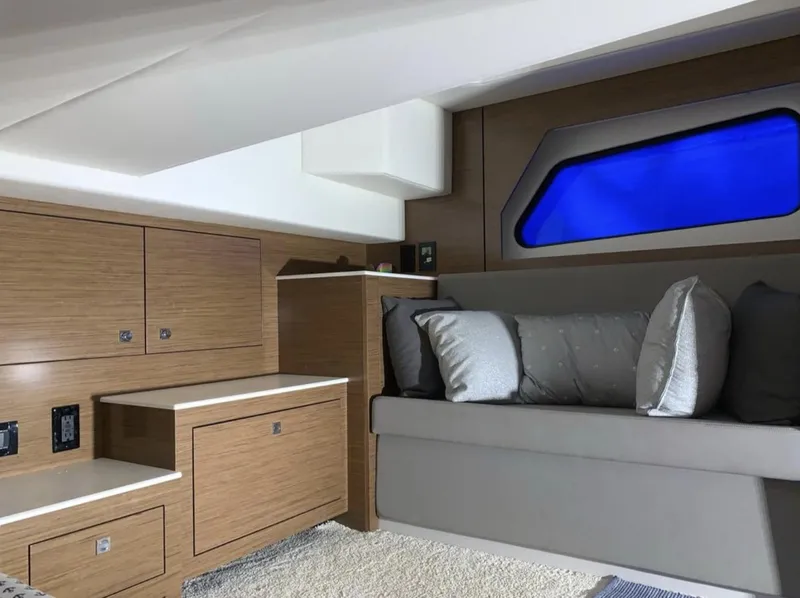 Slide: The Image of 2018 Cruisers 390 Express Coupe interior with modern wood cabinetry and cozy seating. - 16