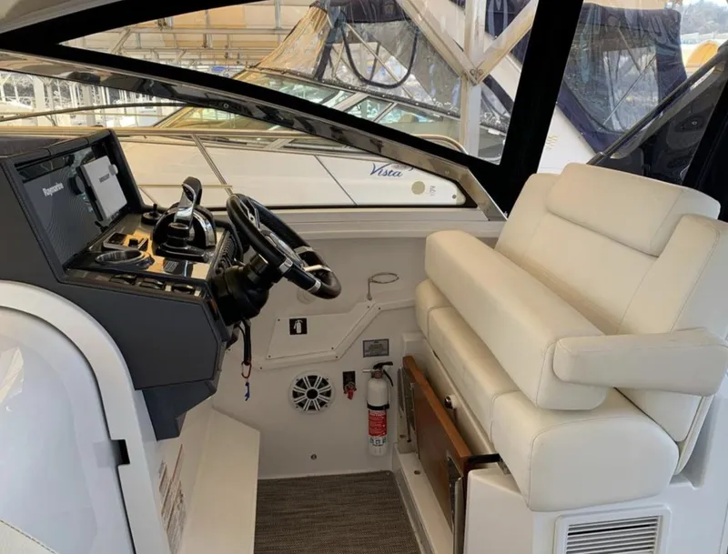 Slide: The Image of 2018 Cruisers 390 Express Coupe helm with modern controls and plush seating. - 6