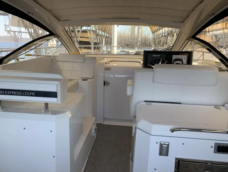 Slide: The Image of 2018 Cruisers 390 Express Coupe interior with white seating and modern dashboard. - 7