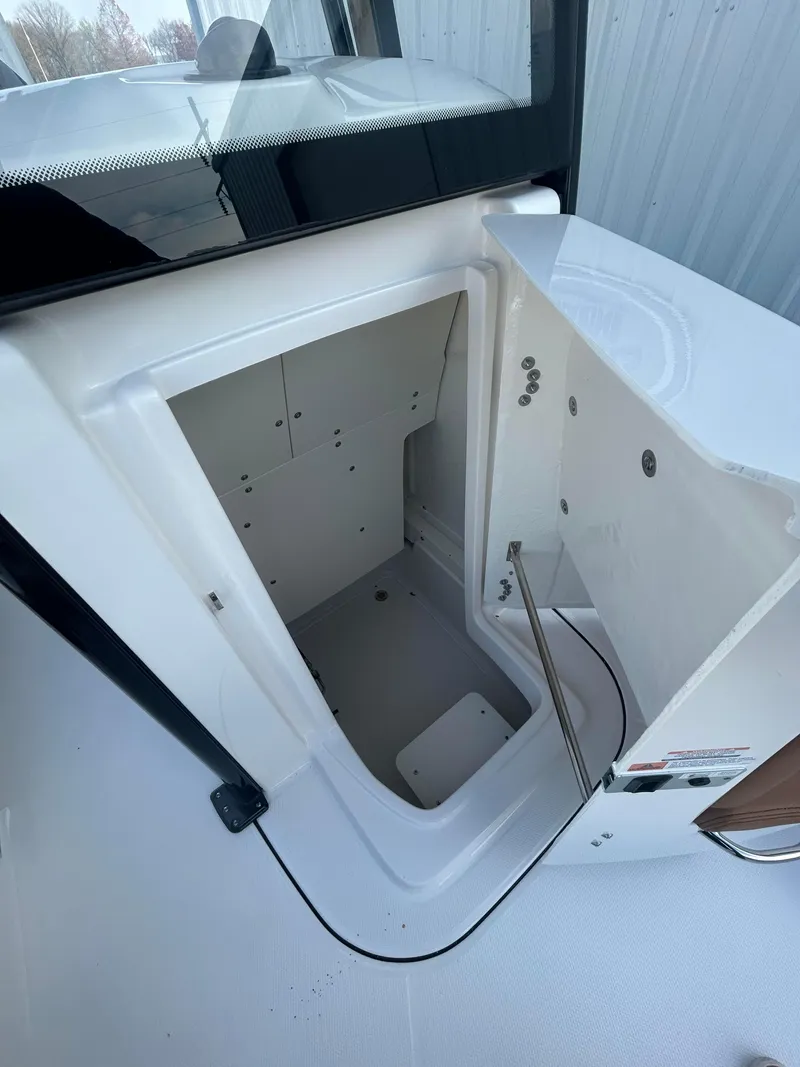 Slide: The Image of 2025 Robalo 246 Cayman boat storage compartment, open hatch view. - 10