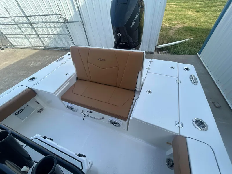 Slide: The Image of 2025 Robalo 246 Cayman boat interior with tan seating and storage compartments. - 6