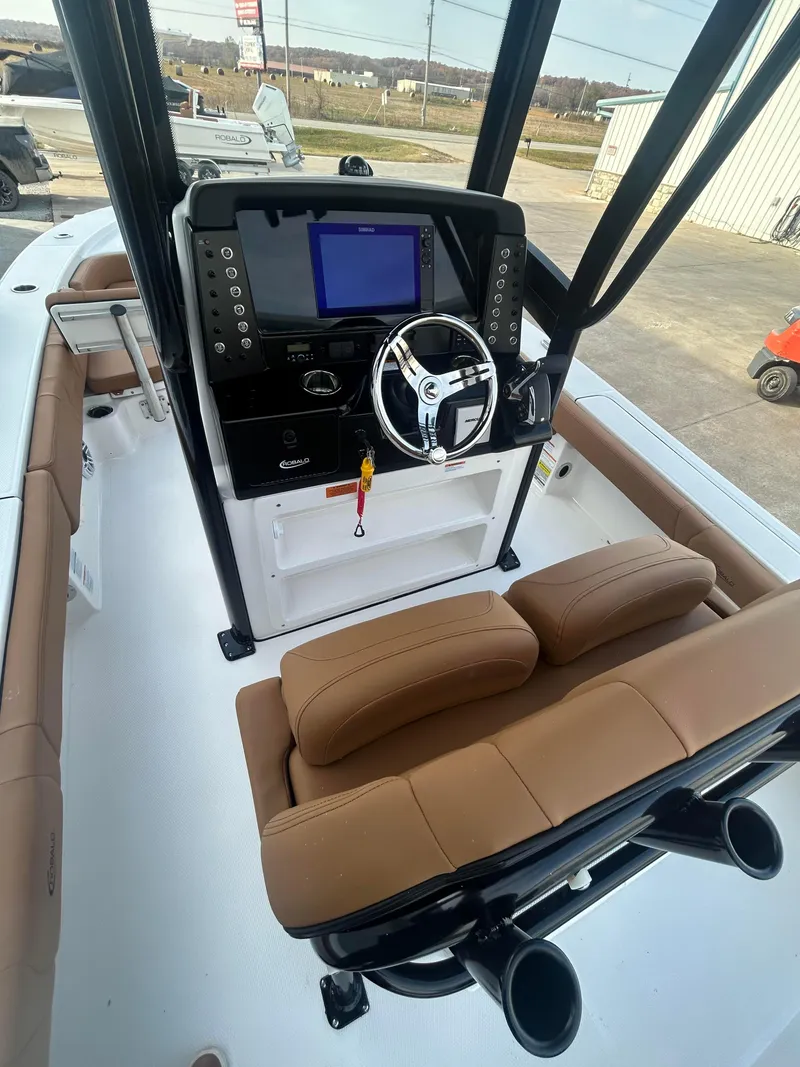 Slide: The Image of 2025 Robalo 246 Cayman boat interior with modern console and seating. - 7