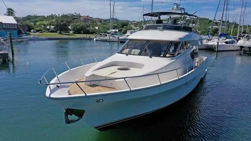 The Image of 2004 McKinna Pilothouse yacht docked in a serene marina setting. - 1