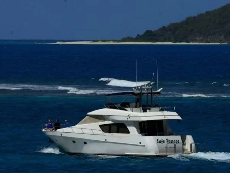 Slide: The Image of 2004 McKinna Pilothouse yacht cruising near a scenic island coastline. - 10
