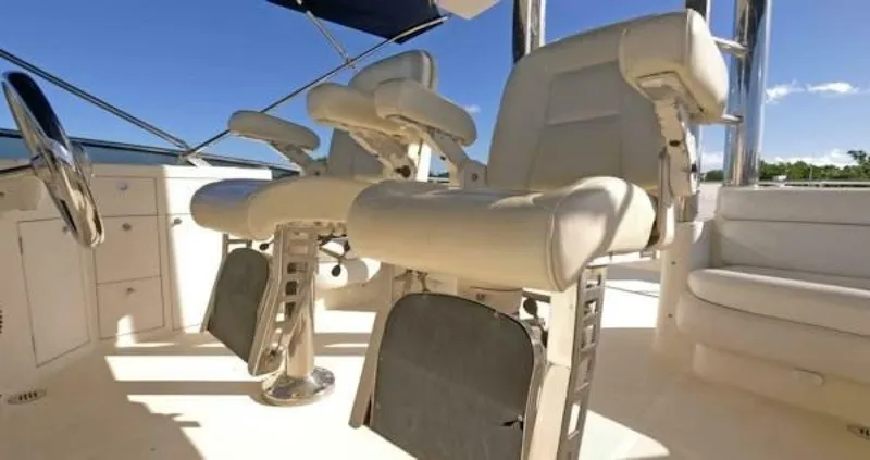 Slide: The Image of 2004 McKinna Pilothouse interior with luxurious white captain chairs and helm station. - 12