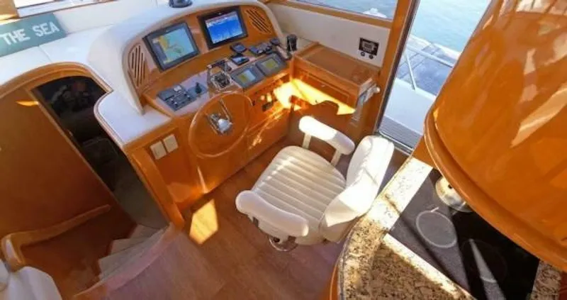Slide: The Image of 2004 McKinna Pilothouse yacht interior with navigation controls and captain's chair. - 13
