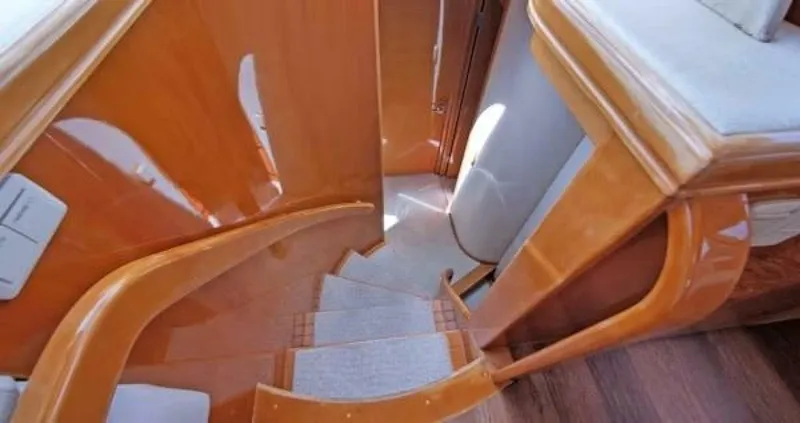 Slide: The Image of Staircase inside 2004 McKinna Pilothouse yacht with polished wood finish. - 16