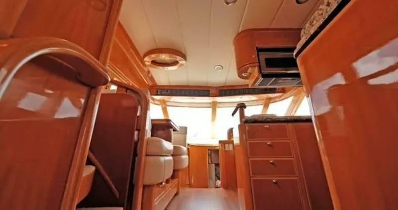 Slide: The Image of Interior of 2004 McKinna Pilothouse yacht, featuring wood finishes and modern amenities. - 17