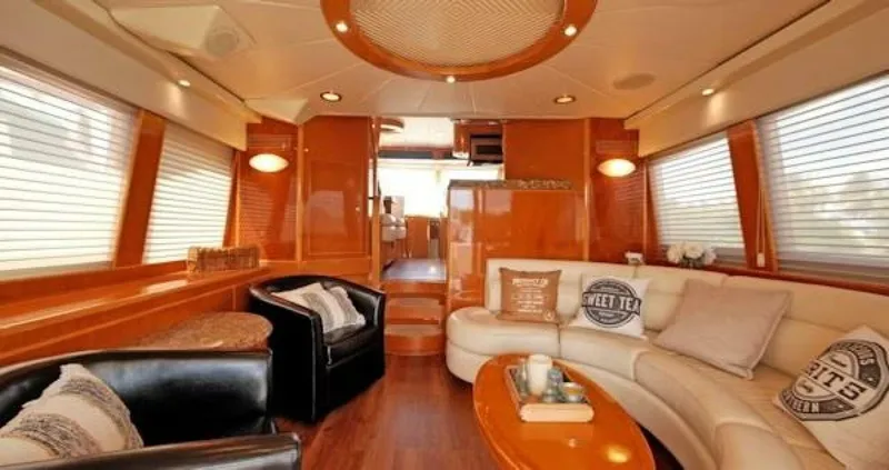 Slide: The Image of Luxurious interior of a 2004 McKinna Pilothouse yacht with elegant seating and wood finishes. - 20