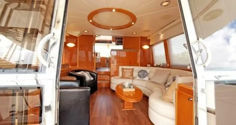 Slide: The Image of Luxurious interior of a 2004 McKinna Pilothouse yacht with elegant seating and wood finishes. - 23