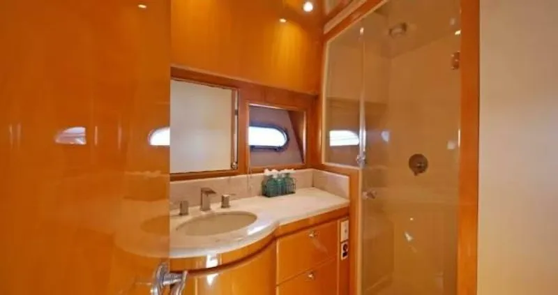 Slide: The Image of Luxurious bathroom in 2004 McKinna Pilothouse yacht with wooden cabinetry and modern fixtures. - 24