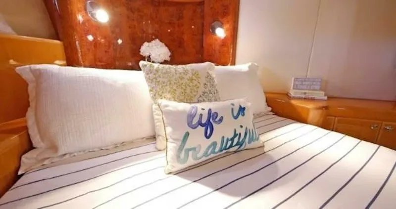 Slide: The Image of Cozy bedroom in 2004 McKinna Pilothouse yacht with decorative pillows and striped bedding. - 26