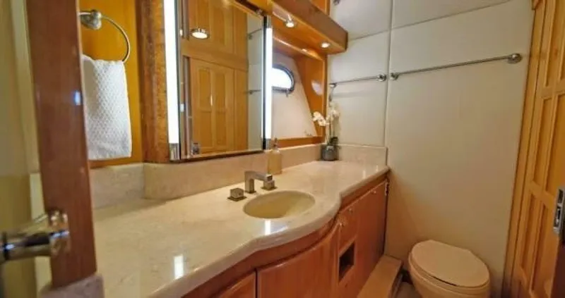 Slide: The Image of Luxurious bathroom in a 2004 McKinna Pilothouse yacht with elegant fixtures and wooden cabinetry. - 27