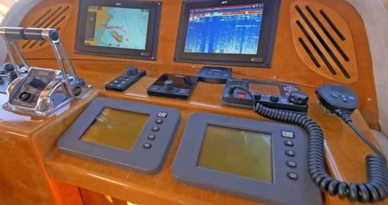 Slide: The Image of 2004 McKinna Pilothouse dashboard with navigation screens and controls. - 30