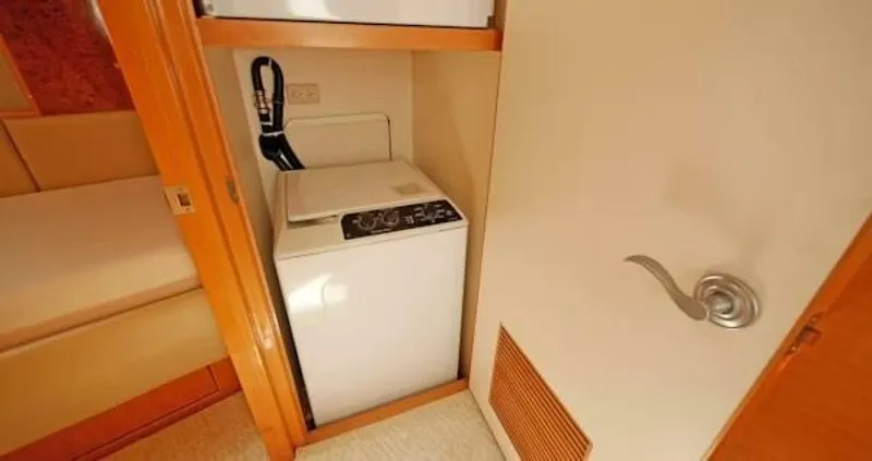 Slide: The Image of 2004 McKinna Pilothouse interior with compact washing machine in cabin space. - 32