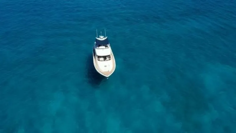Slide: The Image of 2004 McKinna Pilothouse yacht on clear blue ocean water. - 5