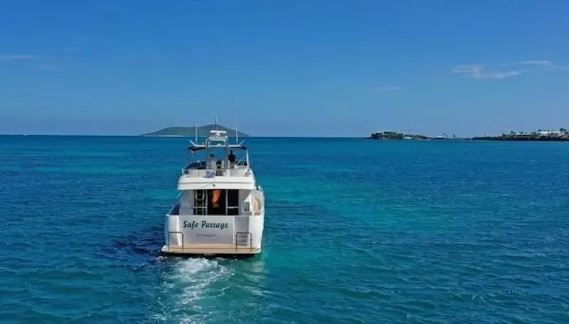 Slide: The Image of 2004 McKinna Pilothouse cruising in clear blue ocean waters under a sunny sky. - 6
