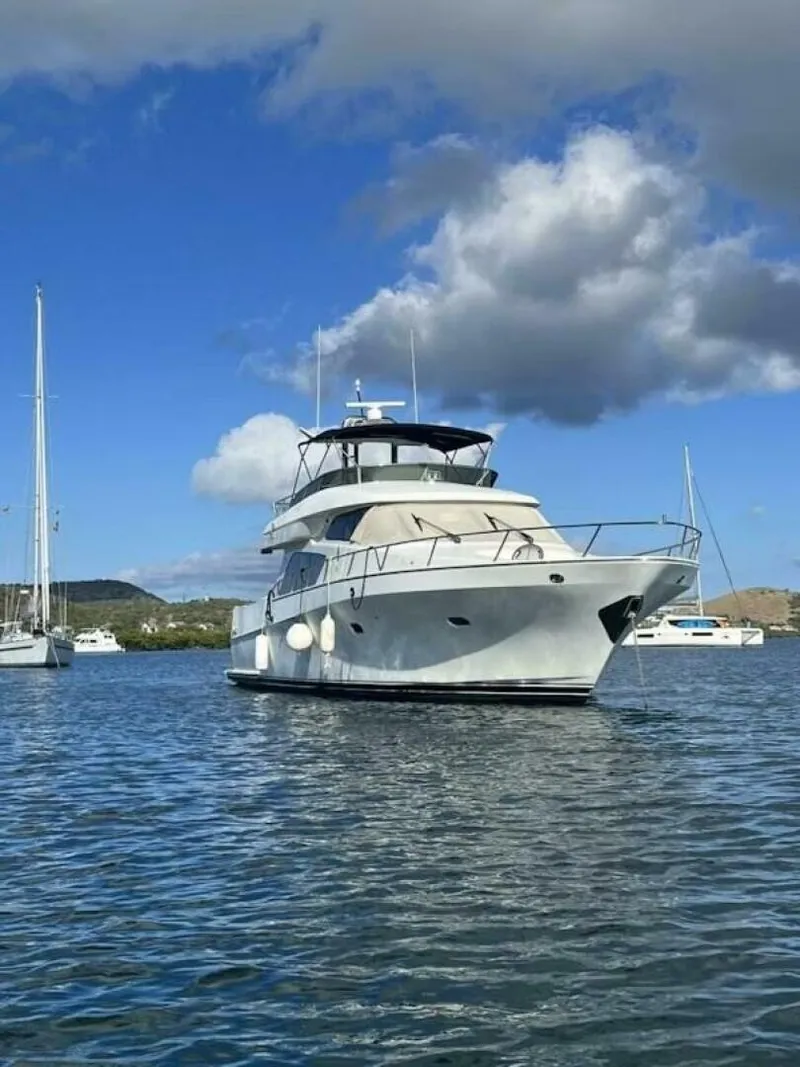 Slide: The Image of 2004 McKinna Pilothouse yacht on calm water under a partly cloudy sky. - 7