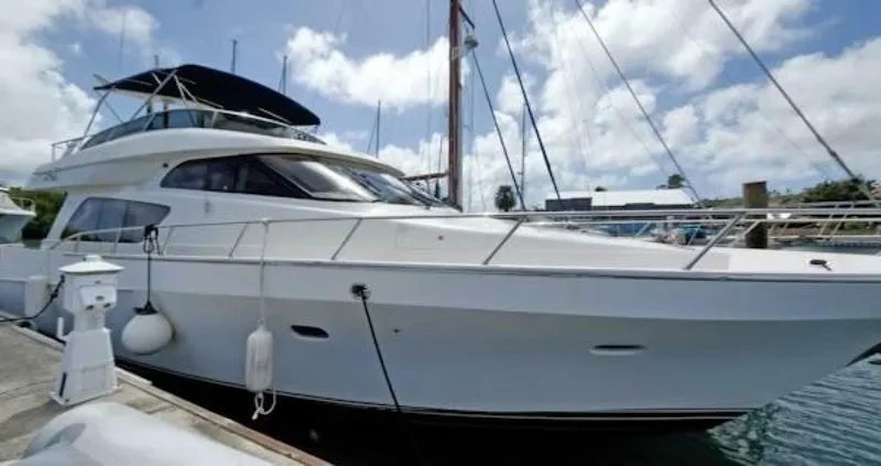Slide: The Image of 2004 McKinna Pilothouse yacht docked at marina under a partly cloudy sky. - 8