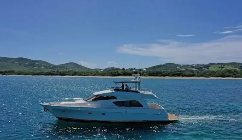 Slide: The Image of 2004 McKinna Pilothouse yacht cruising on clear blue waters near a scenic coastline. - 9