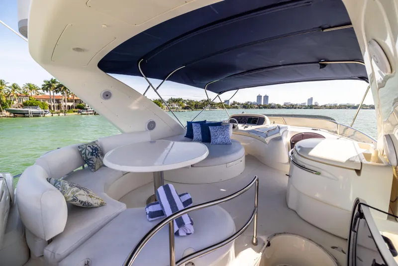 Slide: The Image of Luxurious 2005 Azimut 68 yacht deck with seating, table, and ocean view. - 11