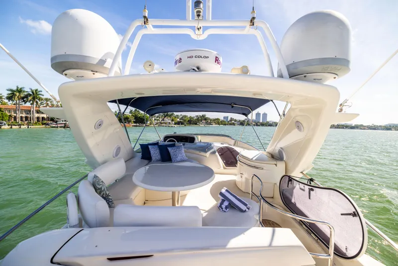 Slide: The Image of Luxurious 2005 Azimut 68 yacht with spacious deck and seating, cruising on serene waters. - 13