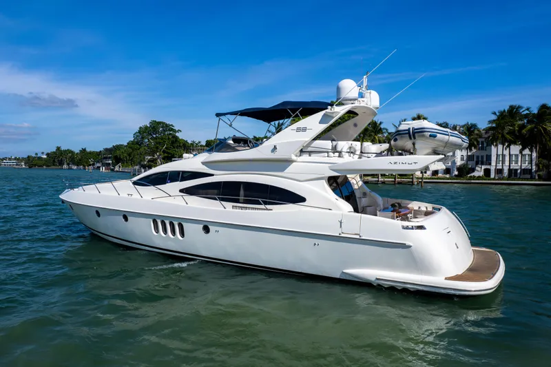 Slide: The Image of 2005 Azimut 68 yacht cruising on a sunny day, featuring sleek design and luxurious amenities. - 2