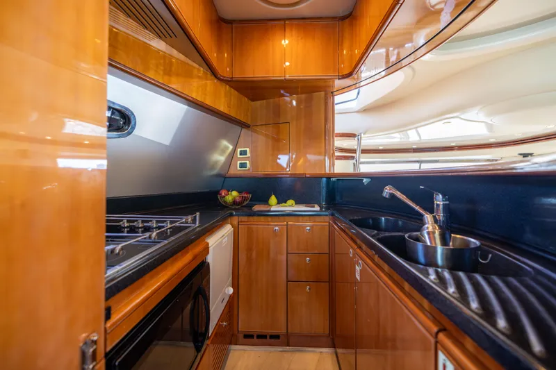 Slide: The Image of Luxurious kitchen interior of 2005 Azimut 68 yacht with wood cabinetry and modern appliances. - 22