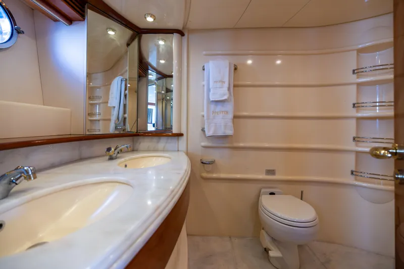 Slide: The Image of Luxurious bathroom in a 2005 Azimut 68 yacht with dual sinks and elegant fixtures. - 26