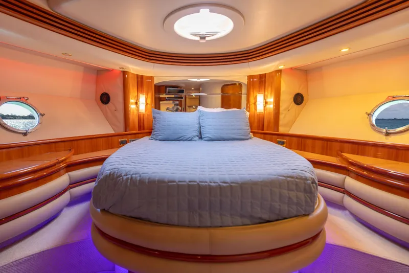 Slide: The Image of Luxurious bedroom interior of 2005 Azimut 68 yacht with circular bed and ambient lighting. - 27
