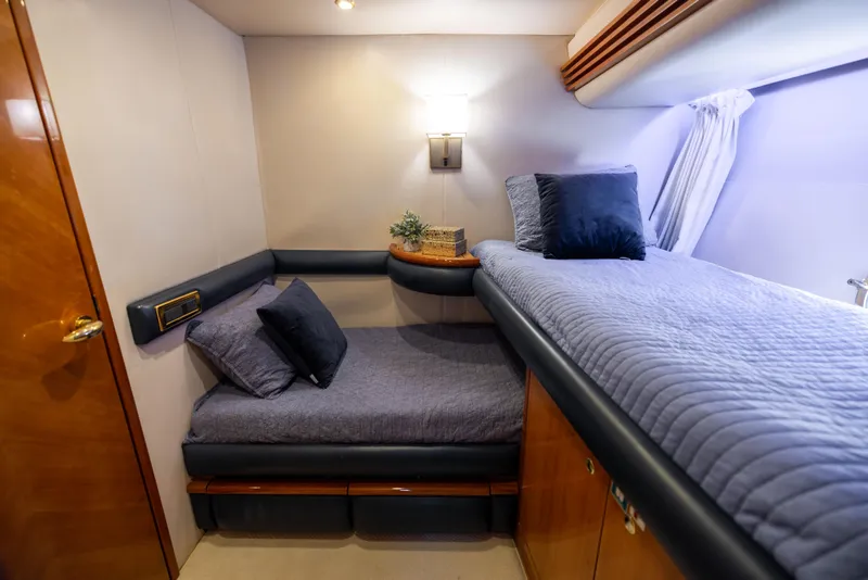 Slide: The Image of Luxurious cabin interior of 2005 Azimut 68 yacht with cozy bedding and elegant decor. - 29