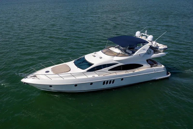 Slide: The Image of 2005 Azimut 68 yacht cruising on open water, side view. - 3
