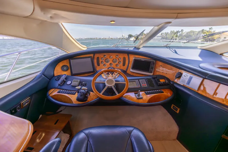 Slide: The Image of Luxurious 2005 Azimut 68 yacht helm with wood accents and modern navigation equipment. - 31