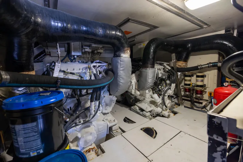 Slide: The Image of Engine room of a 2005 Azimut 68 yacht, featuring complex machinery and piping. - 32