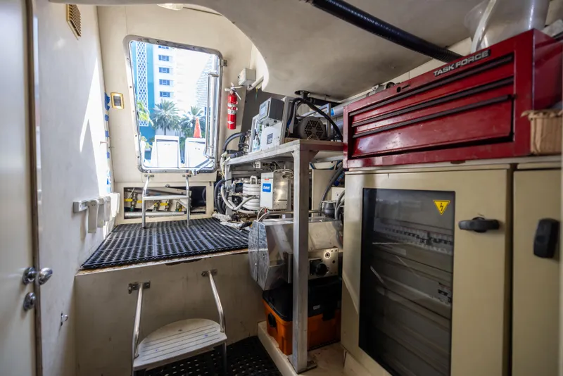 Slide: The Image of Engine room of a 2005 Azimut 68 yacht with equipment and storage. - 33