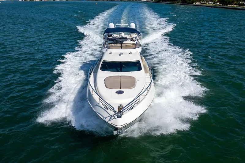 Slide: The Image of 2005 Azimut 68 yacht cruising on open water, creating a dynamic wake. - 4