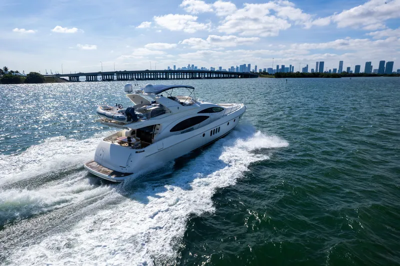 Slide: The Image of Luxurious 2005 Azimut 68 yacht cruising on open water near a city skyline. - 5